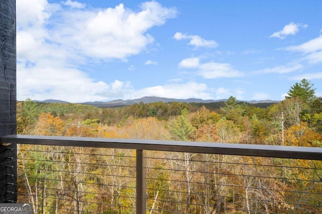 balcony with a mountain view and a wooded view