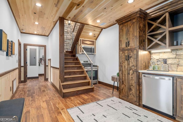 interior space with wood finished floors, a wainscoted wall, recessed lighting, wood ceiling, and appliances with stainless steel finishes