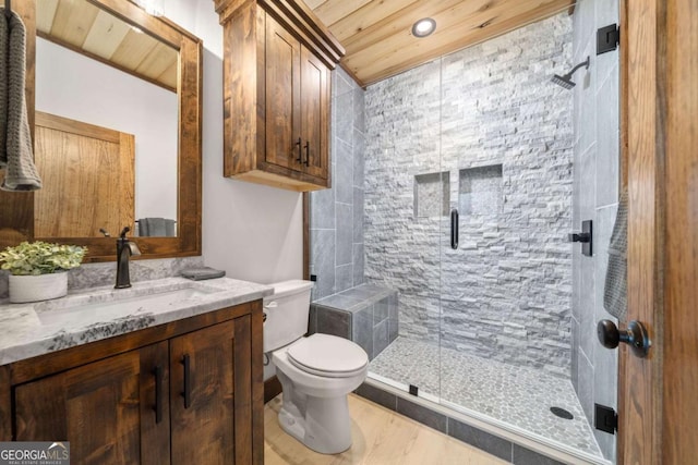 bathroom featuring vanity, toilet, wood ceiling, and a stall shower