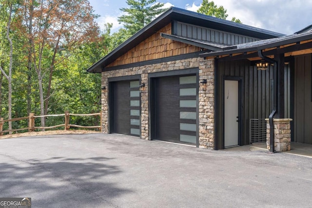 detached garage featuring fence