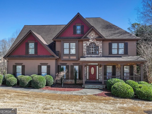 view of front of property featuring stone siding and covered porch