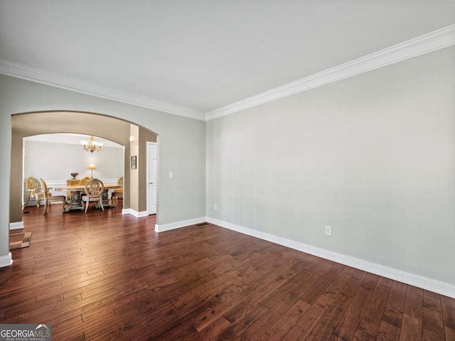9035 Forest Path Dr, Gainesville, GA 30506 - unfurnished room featuring arched walkways, crown molding, dark wood-style flooring, and a chandelier
