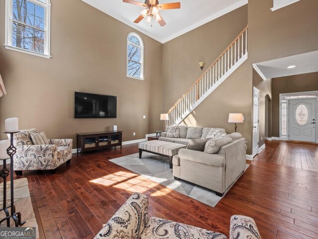 9035 Forest Path Dr, Gainesville, GA 30506 - living area featuring hardwood / wood-style flooring, ornamental molding, ceiling fan, a towering ceiling, and arched walkways
