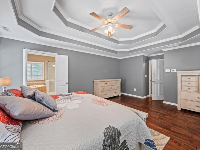 bedroom with visible vents, a raised ceiling, baseboards, and wood finished floors