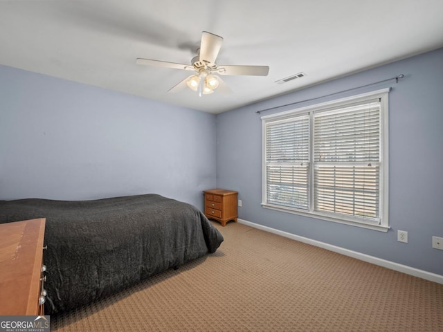 carpeted bedroom with visible vents, baseboards, and ceiling fan