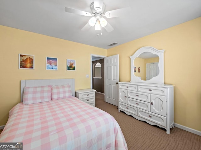 bedroom with a ceiling fan, light colored carpet, visible vents, and baseboards