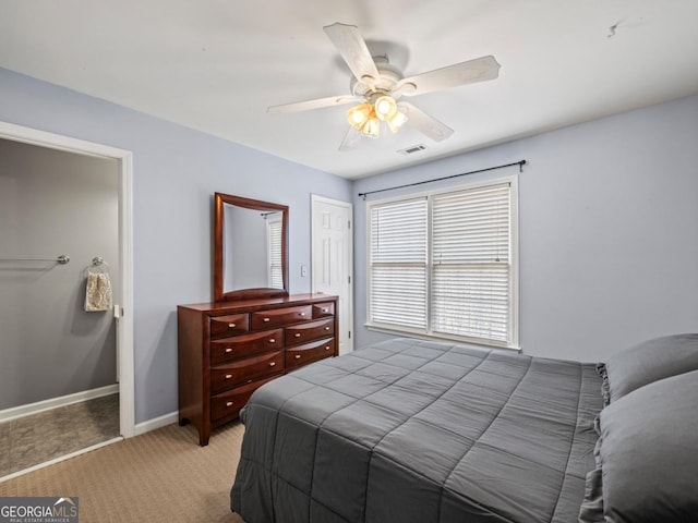 bedroom with visible vents, light carpet, baseboards, and ceiling fan