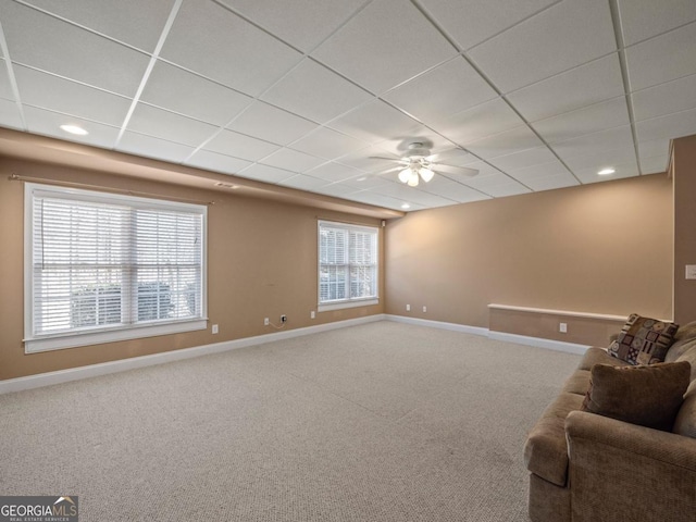 unfurnished living room featuring baseboards, a drop ceiling, carpet flooring, recessed lighting, and a ceiling fan