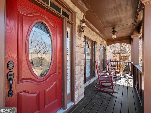 doorway to property featuring stone siding and a porch