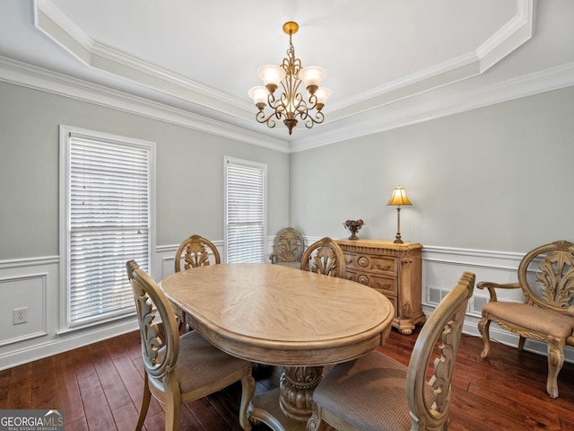 9035 Forest Path Dr, Gainesville, GA 30506 - dining room with a tray ceiling, a chandelier, dark wood-style flooring, a wainscoted wall, and crown molding