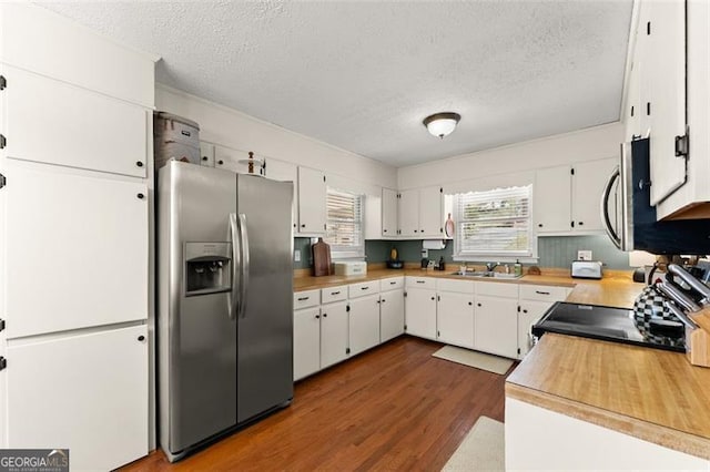 kitchen featuring stainless steel appliances, a textured ceiling, dark wood-style floors, and white cabinetry