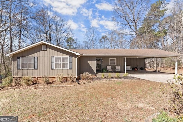 ranch-style home featuring an attached carport and driveway