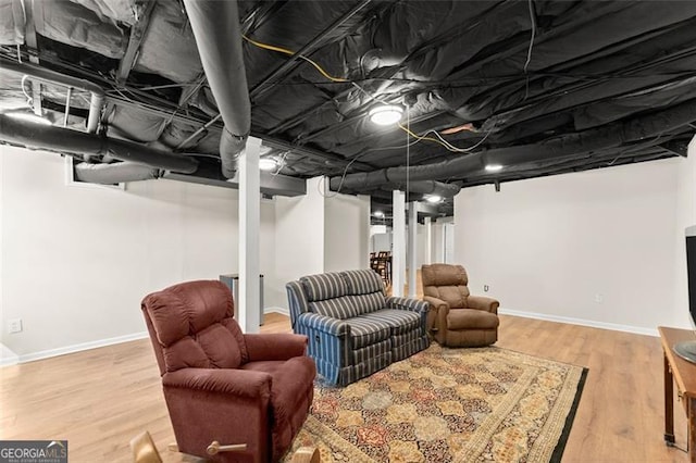 finished basement with baseboards and wood finished floors