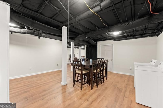 dining space featuring wood finished floors, washing machine and dryer, and baseboards