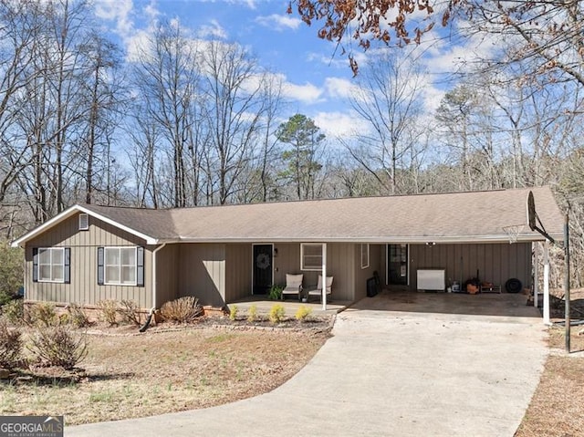 single story home with an attached carport and driveway