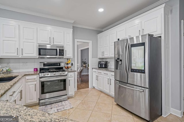 kitchen featuring white cabinetry, light tile patterned floors, and appliances with stainless steel finishes