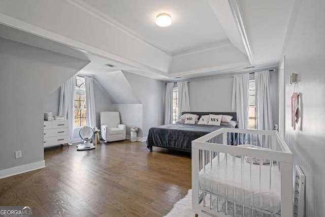 bedroom featuring ornamental molding, baseboards, and wood finished floors