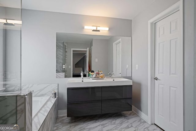 ensuite bathroom featuring ensuite bath, double vanity, a sink, a garden tub, and marble finish floor