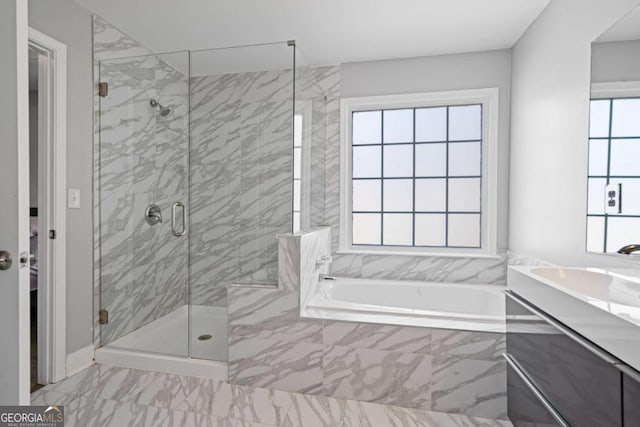 full bathroom with a garden tub, marble finish floor, a stall shower, and vanity