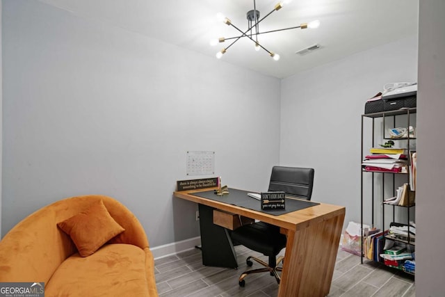 office area featuring a notable chandelier, visible vents, baseboards, and wood finish floors