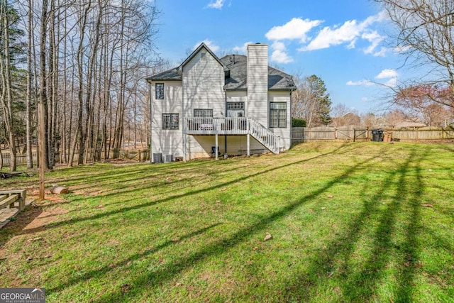 back of house with fence, a yard, stairway, cooling unit, and a chimney