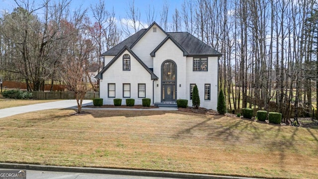 view of front of home with a front lawn and fence