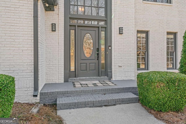 property entrance with brick siding