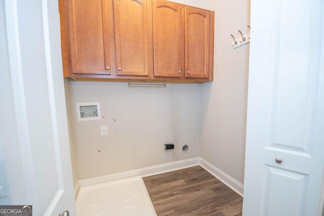 clothes washing area featuring baseboards, cabinet space, dark wood-style floors, and hookup for a washing machine