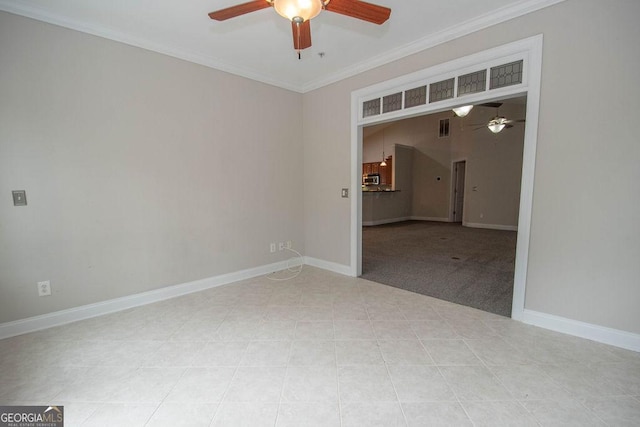 empty room with visible vents, a ceiling fan, and crown molding