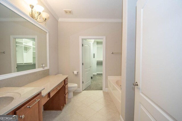 bathroom featuring vanity, a bath, visible vents, ornamental molding, and toilet