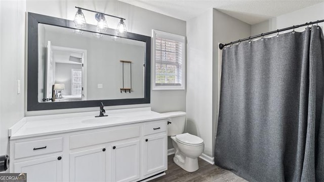 full bath with curtained shower, toilet, vanity, and wood finished floors