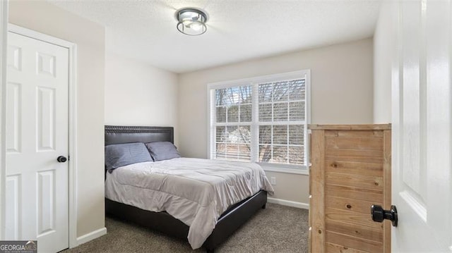 bedroom featuring baseboards and carpet