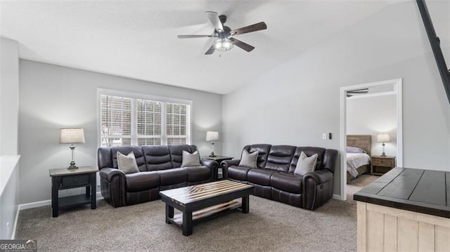 living room with a ceiling fan, vaulted ceiling, carpet, and baseboards