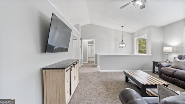 living room featuring lofted ceiling, ceiling fan with notable chandelier, baseboards, and light carpet