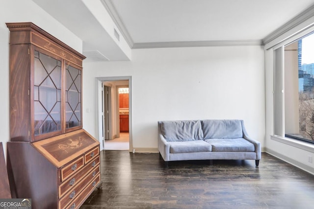 living area with visible vents, baseboards, dark wood-type flooring, and ornamental molding