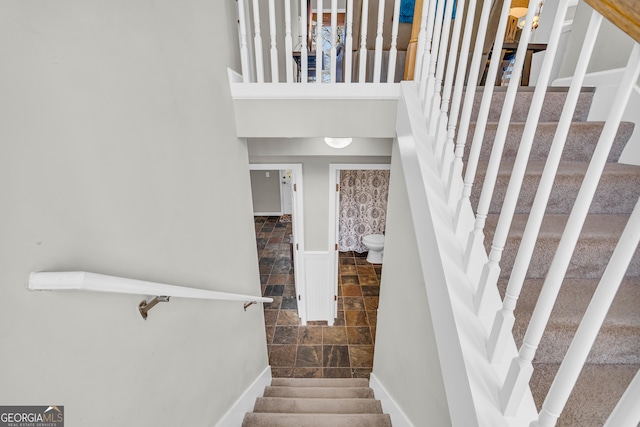 stairs with stone finish flooring and baseboards