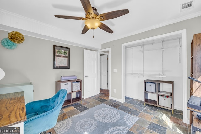 office area featuring visible vents, crown molding, ceiling fan, baseboards, and stone tile floors