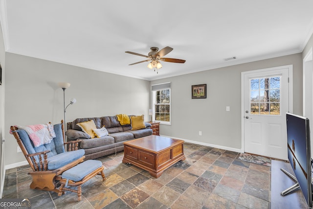 living area featuring baseboards, plenty of natural light, and visible vents