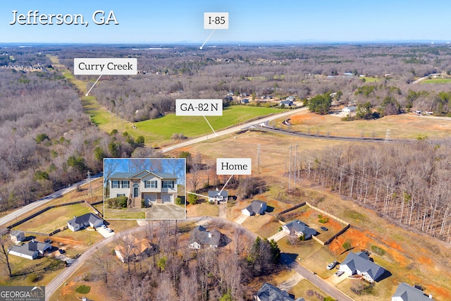 birds eye view of property with a rural view