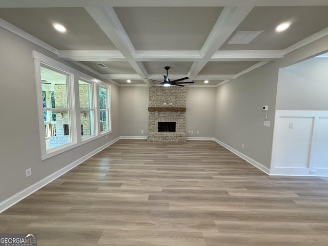 73 Hewett Rd, Pendergrass, GA 30567 - unfurnished living room with ceiling fan, beamed ceiling, a fireplace, light wood-style floors, and recessed lighting
