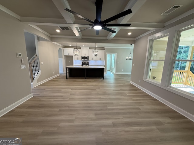 73 Hewett Rd, Pendergrass, GA 30567 - unfurnished living room with coffered ceiling, stairway, baseboards, a ceiling fan, and recessed lighting