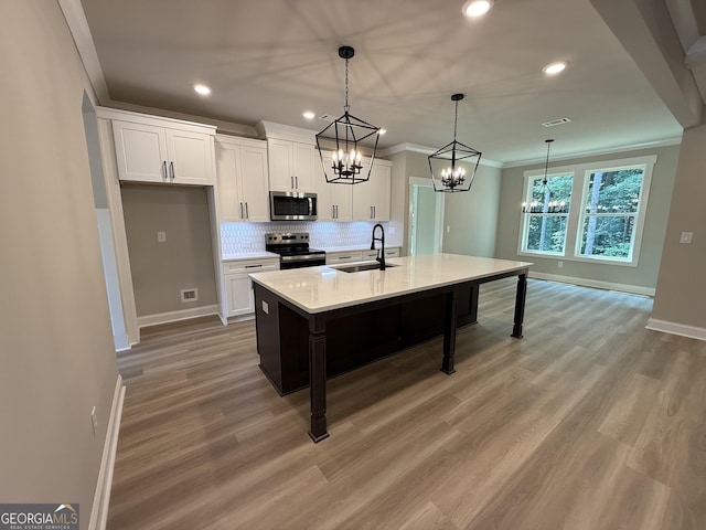 73 Hewett Rd, Pendergrass, GA 30567 - kitchen with appliances with stainless steel finishes, a sink, a chandelier, white cabinetry, and baseboards