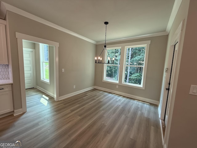 73 Hewett Rd, Pendergrass, GA 30567 - unfurnished dining area featuring crown molding, a chandelier, light wood-type flooring, and baseboards