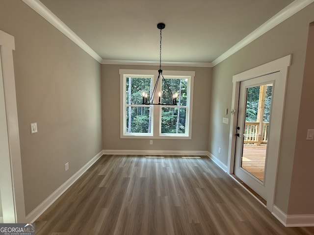 73 Hewett Rd, Pendergrass, GA 30567 - unfurnished dining area featuring wood finished floors, a chandelier, baseboards, and ornamental molding