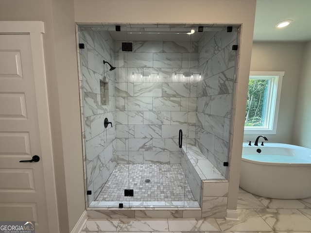 73 Hewett Rd, Pendergrass, GA 30567 - bathroom with marble look tiles, a soaking tub, a shower stall, recessed lighting, and baseboards