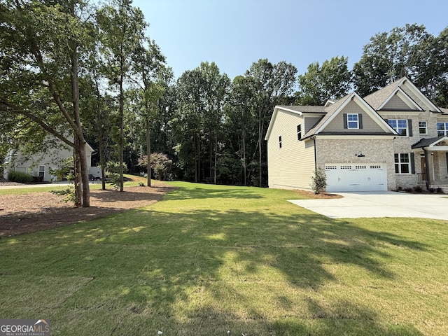 73 Hewett Rd, Pendergrass, GA 30567 - view of side of home featuring concrete driveway, an attached garage, and a lawn