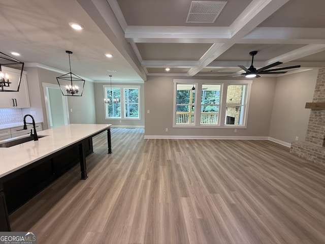 73 Hewett Rd, Pendergrass, GA 30567 - unfurnished living room with a sink, a chandelier, baseboards, recessed lighting, and beamed ceiling