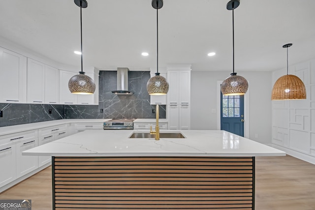 kitchen with stainless steel range with electric stovetop, light wood-style flooring, a sink, backsplash, and wall chimney exhaust hood