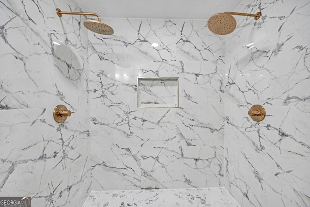 room details featuring a marble finish shower