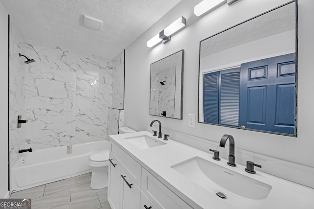 bathroom featuring a textured ceiling, shower / bathing tub combination, toilet, and a sink